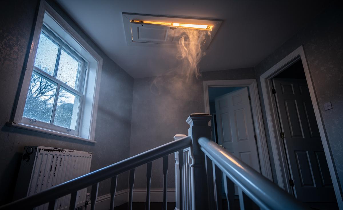 Cracking the loft hatch briefly: how pressure balance reduces upstairs condensation